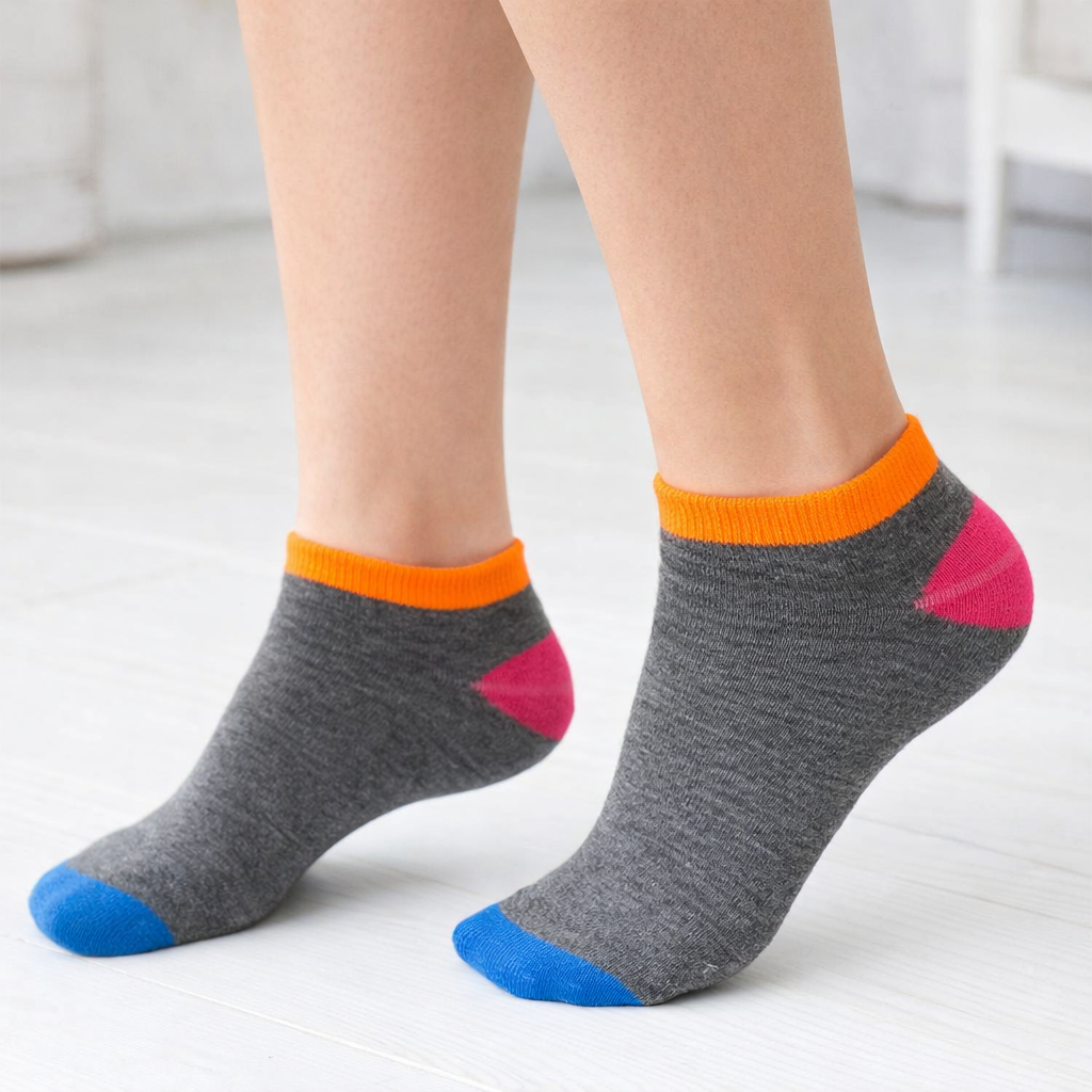 Gray ankle socks with colorful accents worn by a person on a light background